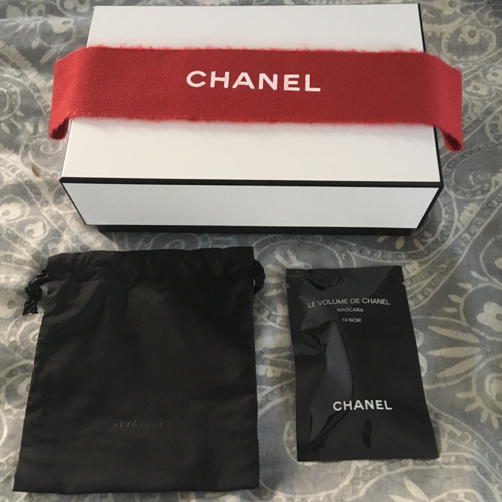 CHANEL rectangular box with red ribbon